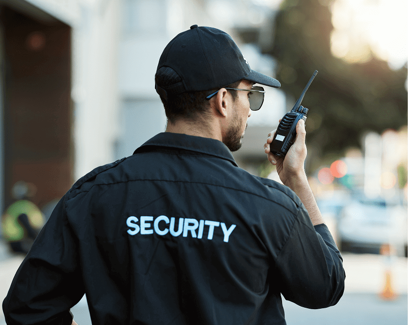 Security guard communicating via walkie-talkie.