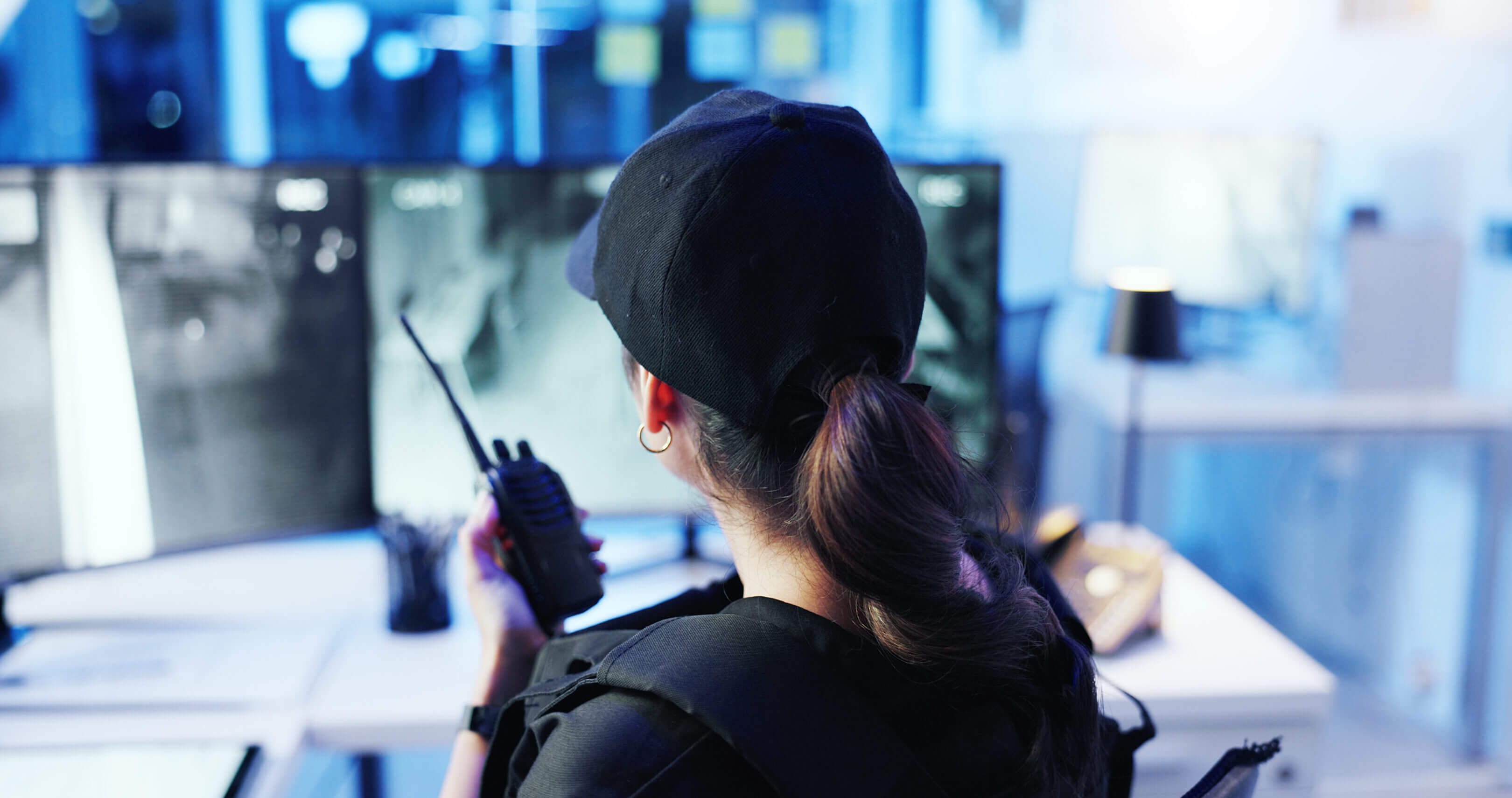 Security officer monitoring surveillance screens.